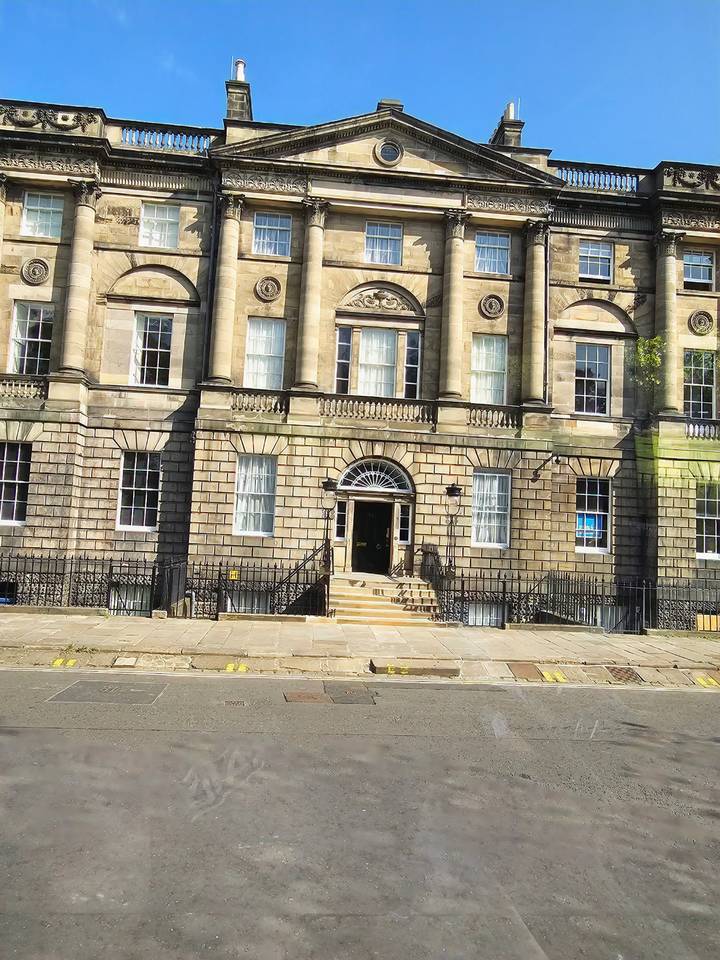 Stone Georgian style townhouse façade taken from a moving bus window