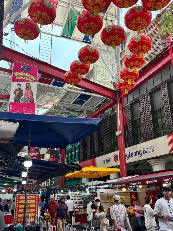 Decorated Chinatown street with red lanterns, signage and shopfronts in Kuala Lumpur