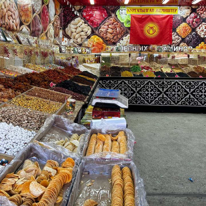 Colourful market stall piled high with dried fruits, nuts and spices