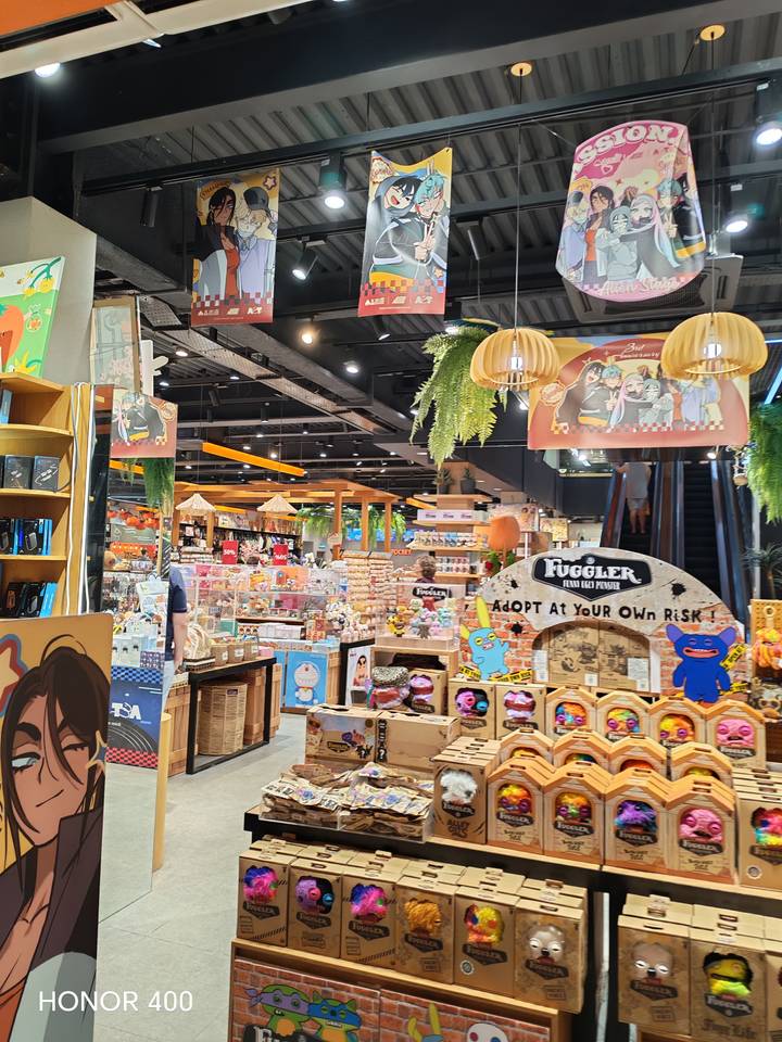 Brightly lit indoor souvenir and toy shop packed with colorful merchandise.