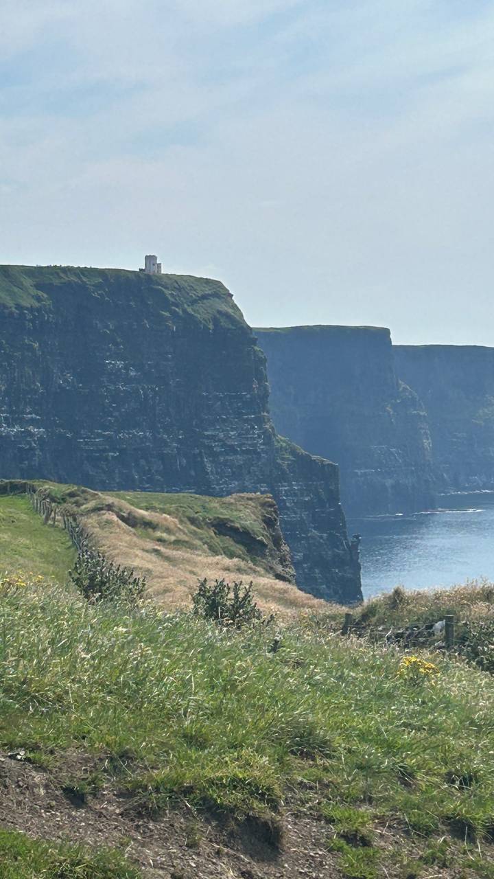 Sheer face of the Cliffs of Moher rising dramatically from the Atlantic Ocean.