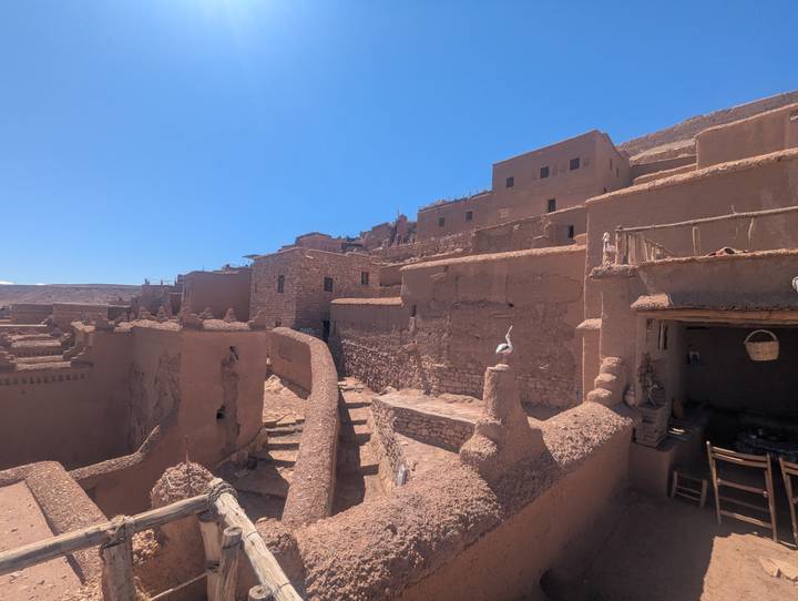 Adobe kasbah buildings and narrow alleyways under bright blue sky at the fortified village of Ait Benhaddou
