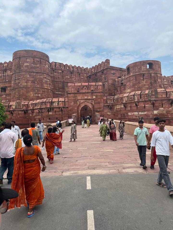 Visitors enter the massive red-sandstone Agra Fort through main gateway.