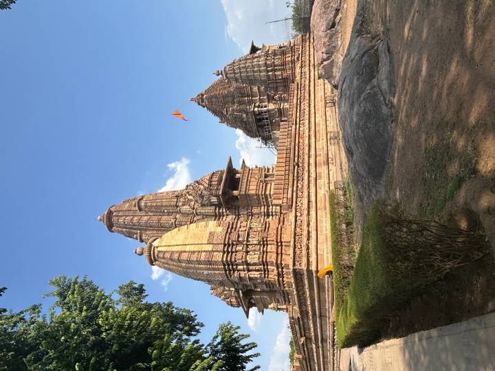 Ornate sandstone Khajuraho temple complex under clear blue sky