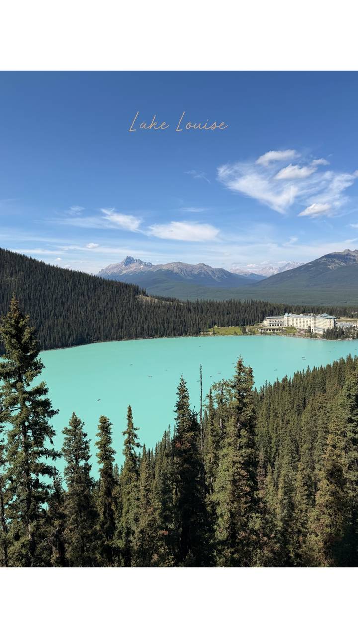 Turquoise Lake Louise with forested shores, chateau hotel and Rocky Mountain peaks.