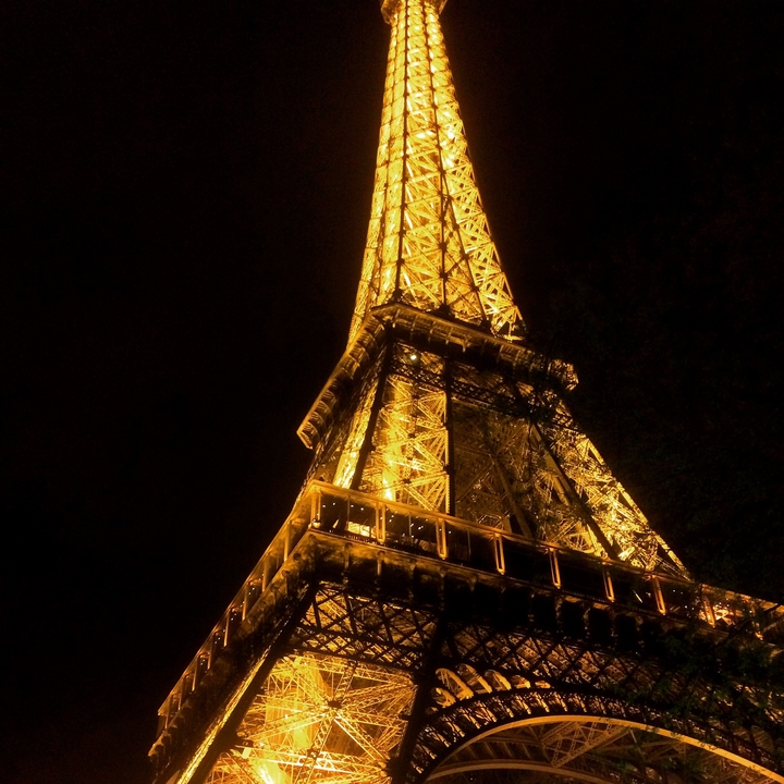 Eiffel Tower illuminated at night.