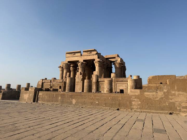 The imposing sandstone columns of Kom Ombo Temple gleaming in bright morning light.