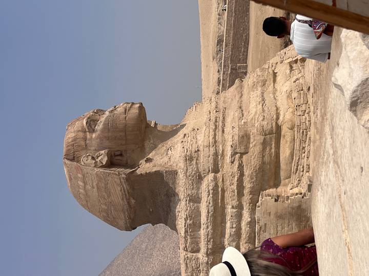 Side view of the Great Sphinx of Giza under a clear blue sky.