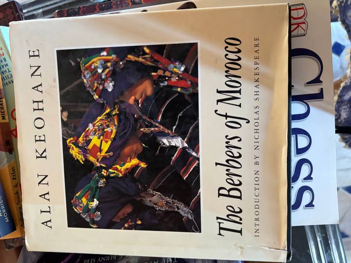 Close-up of a book cover titled 'The Berbers of Morocco' showing an archival photograph of three Berber women.