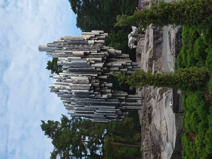 Abstract silver pipes of the Sibelius Monument rising among pine trees in Helsinki.