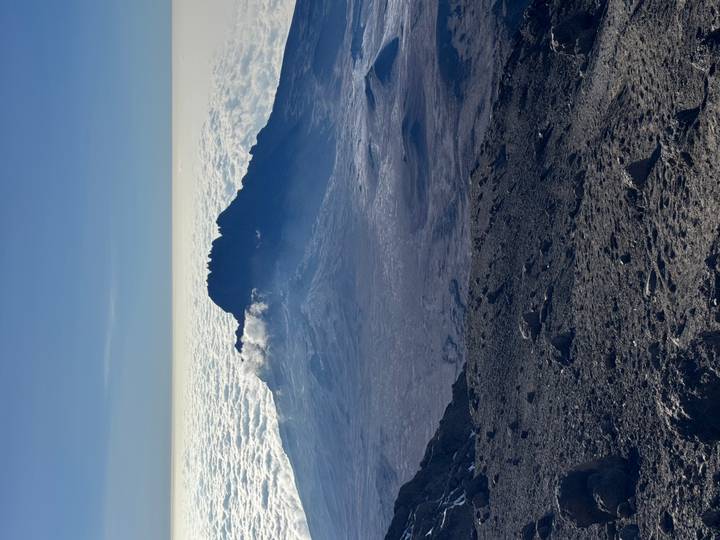 View from high altitude above a sea of clouds with the craggy summit of Mawenzi on Kilimanjaro rising through.