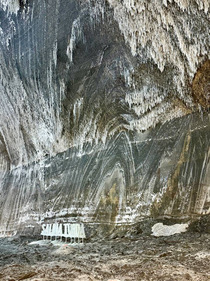 Abstract streaks and stalactite formations on a huge salt mine wall surface.