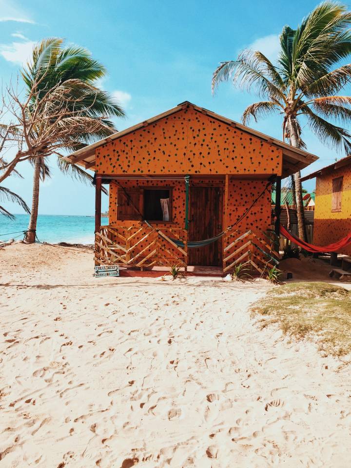 Colorful beach hut near the ocean shore.