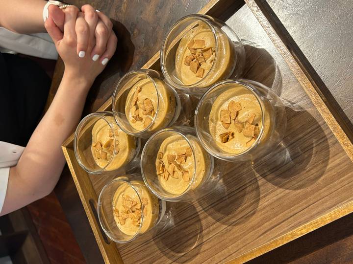 Tray of creamy Vietnamese coffee desserts garnished with almond flakes on a serving board.