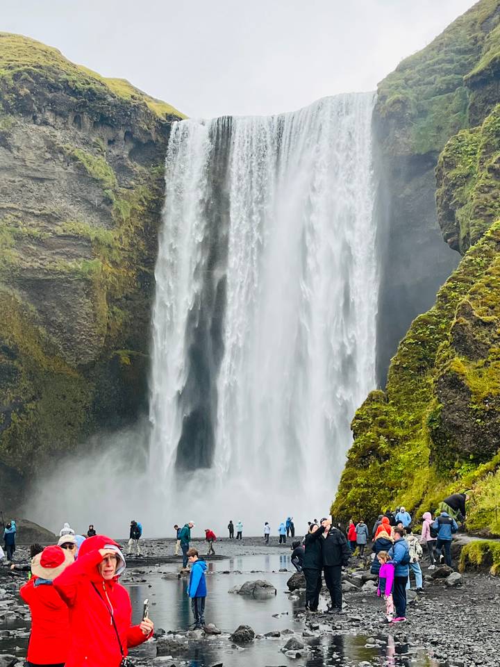 Close-up view of Skogafoss waterfall plunging over mossy cliffs.