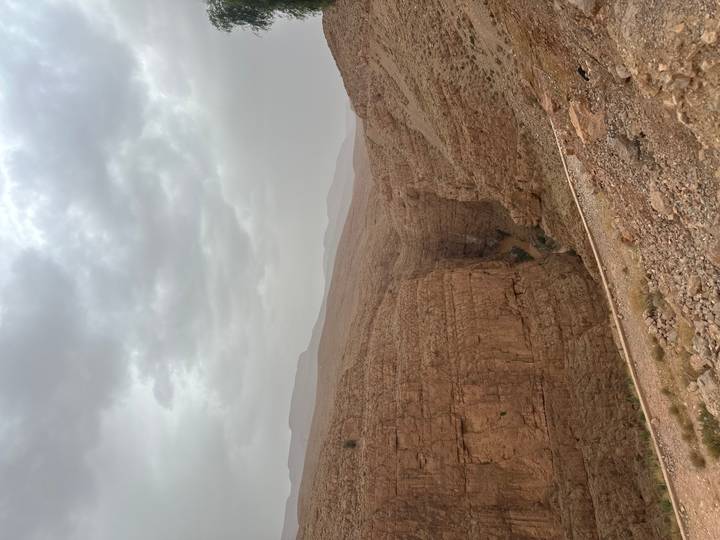 Steep rugged canyon walls under a cloudy sky in the Atlas Mountains
