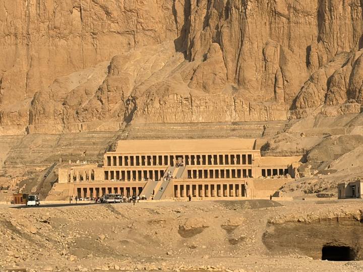 Terraced facade of Hatshepsut’s Mortuary Temple set against towering desert cliffs.