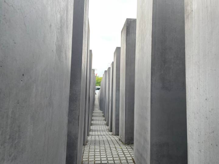 Narrow concrete corridors of Berlin’s Holocaust Memorial leading into the distance.