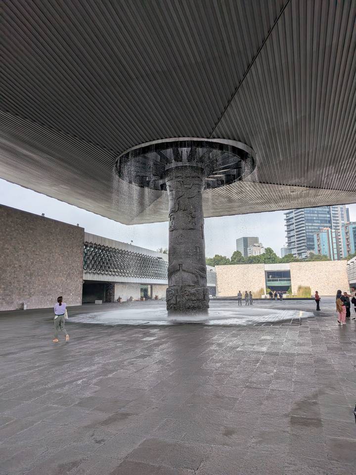 Visitors around the giant umbrella fountain inside Mexico City's National Museum of Anthropology courtyard