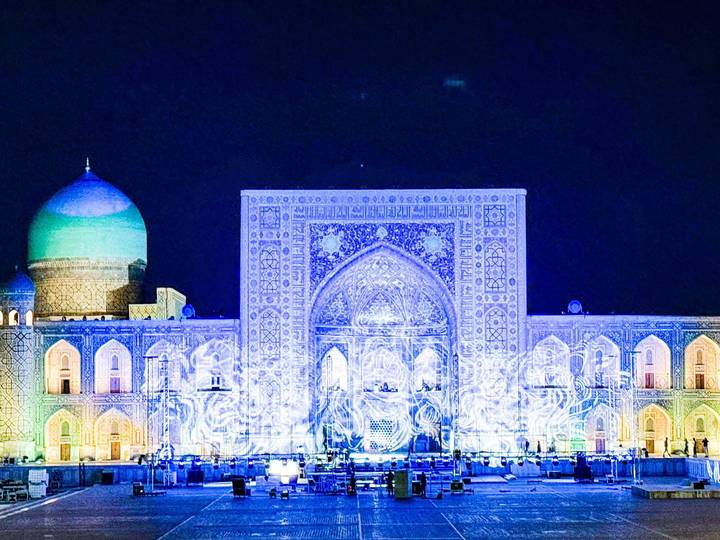 Nighttime light-projection show on the tiled facade of Samarkand’s Registan square.
