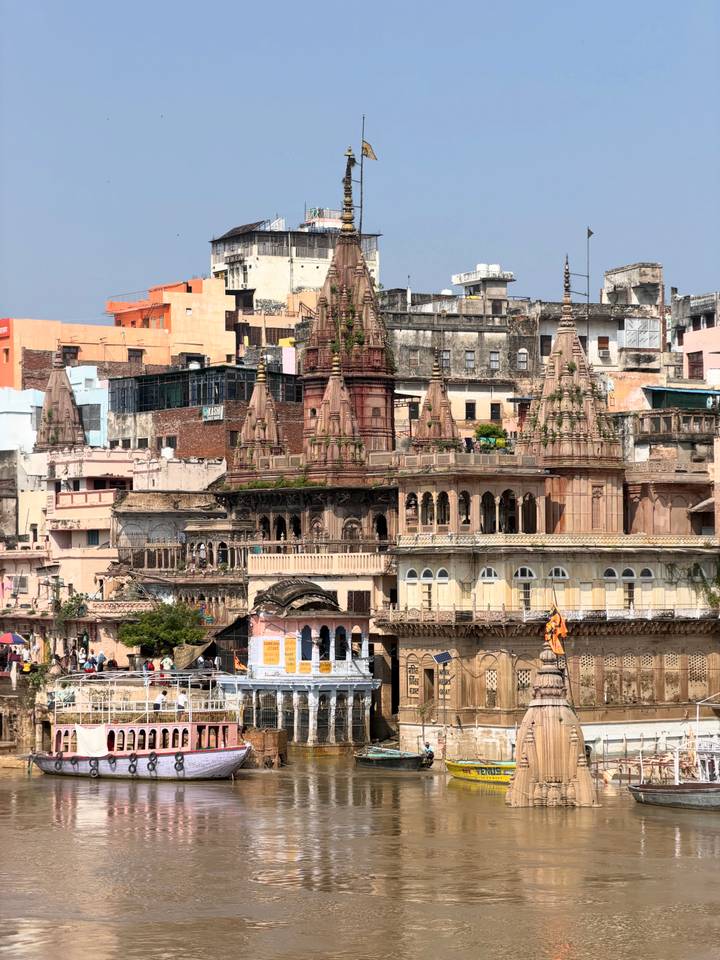 Intricately carved temple spires and old riverside palaces stacked across Varanasi’s ghats.