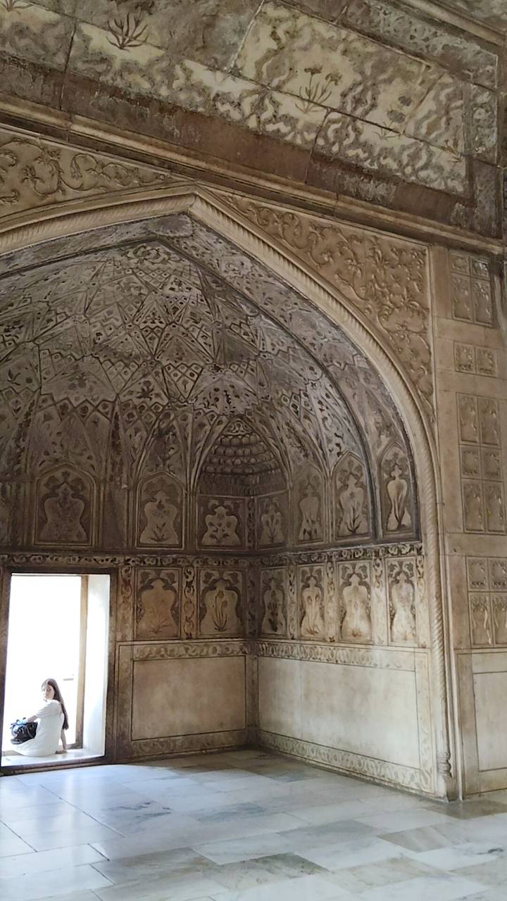 Detailed view of a patterned domed ceiling adorned with geometric and floral motifs.