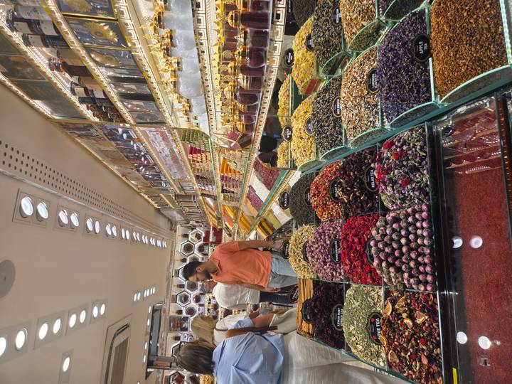 Inside a Turkish spice and tea shop displaying neat rows of colorful dried herbs and sweets.