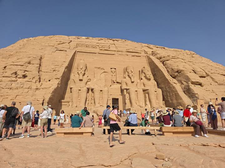 Crowds gather before the colossal seated statues carved into Abu Simbel’s sandstone cliff face.