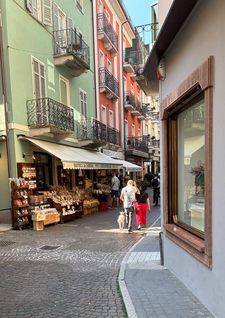 Charming pedestrian street with colorful facades and a shop selling local food products.