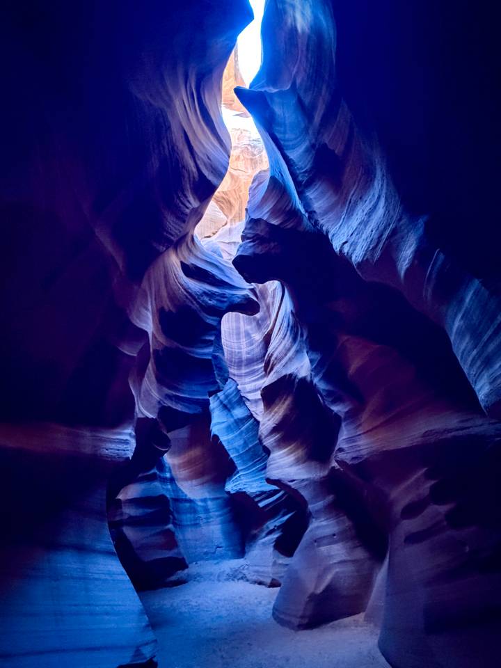 Abstract, richly colored sandstone curves inside Antelope Canyon lit by soft light.