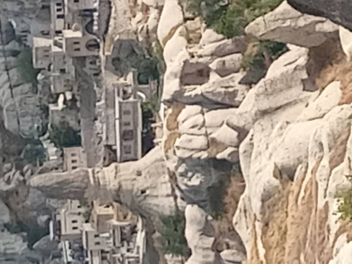 Blurry close-up of strange rock formations and cave houses in Cappadocia.