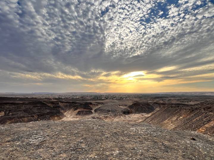 Expansive canyon landscape with dramatic cloud textures and sunbeams breaking through.