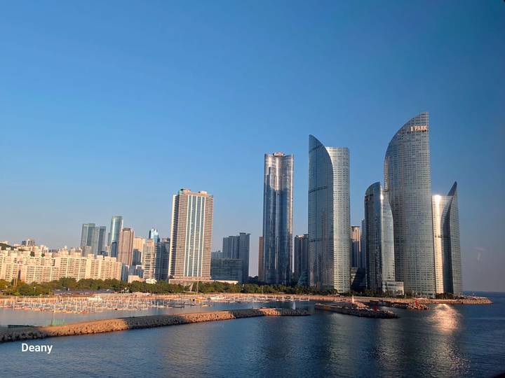Modern high-rise skyline of Busan’s Marine City gleams under a clear afternoon sky.