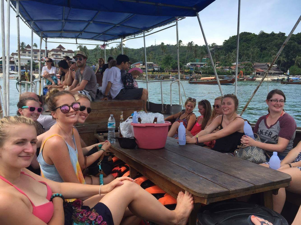 People on a boat with scenic background.
