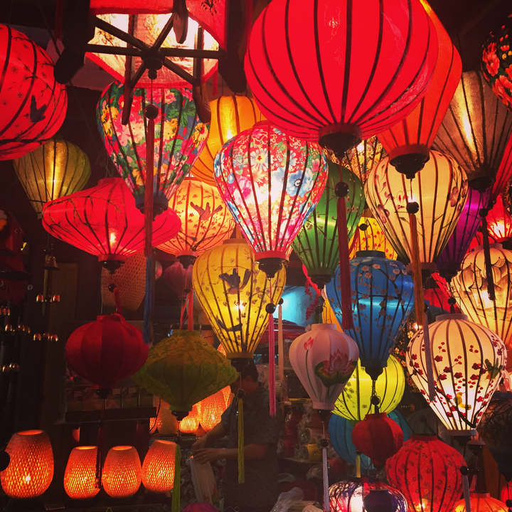 Vibrant colorful lanterns lit up at night.