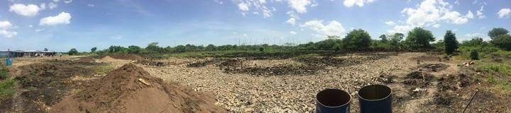 Barren rocky field under a bright blue sky.