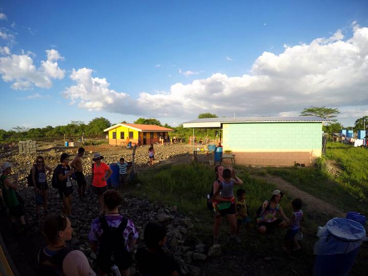 Group of people in a rural area with colorful houses.