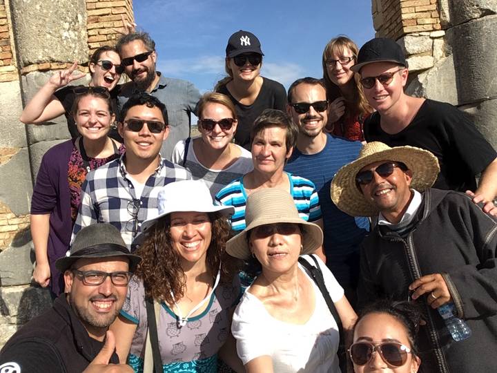 Group of people laughing outdoors.