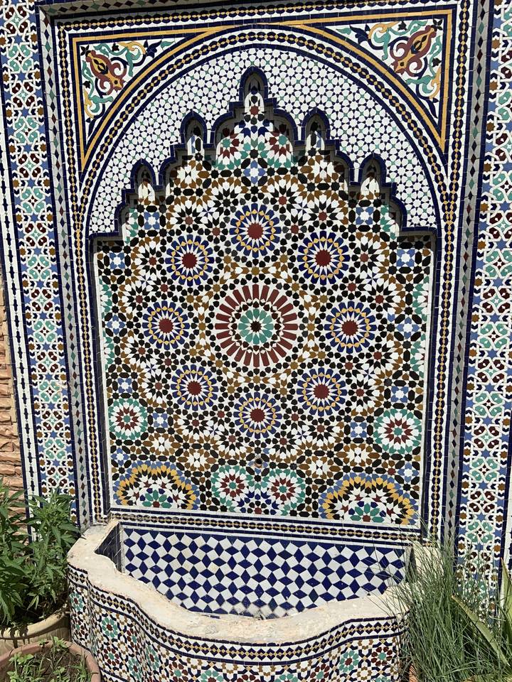 Colorful, intricate mosaic tiles in a traditional pattern.