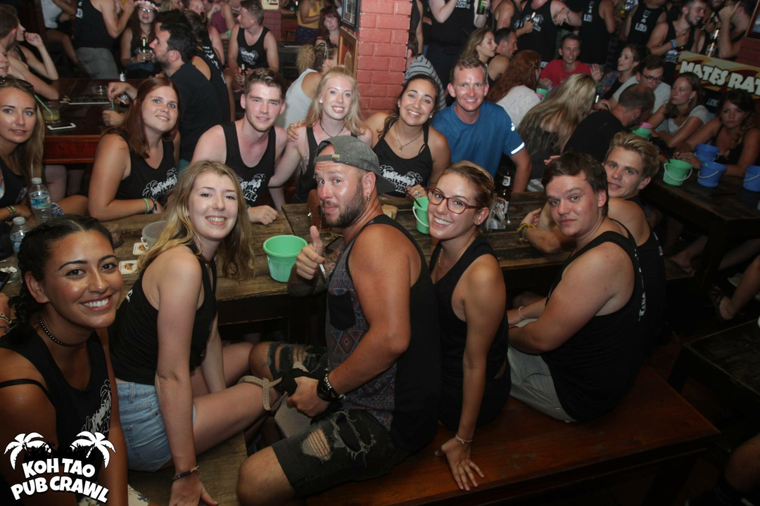 Large group of friends enjoying a meal at a rustic restaurant.