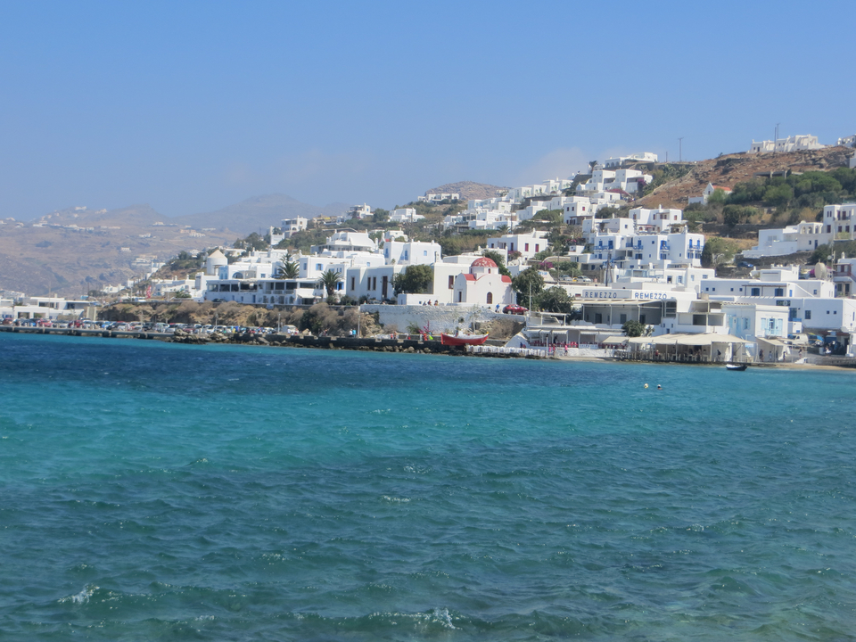 Coastal town with white buildings and blue sea.