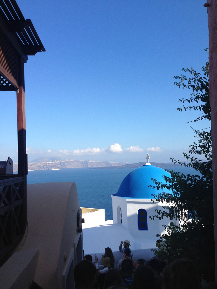 Scenic coastal view with a blue dome church.