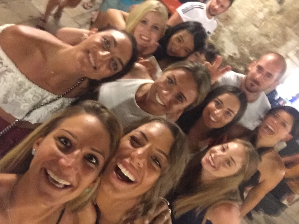 Group of people posing closely together.