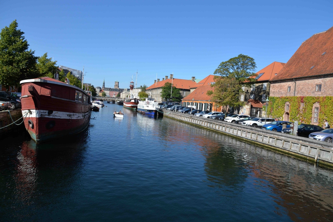 Canal with boats and historic buildings in Copenhagen.