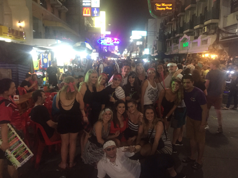 Group of people in a busy street at night.