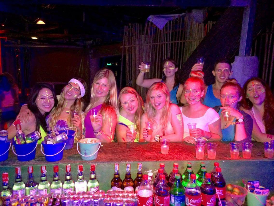 Group of friends enjoying a colorful party indoors.