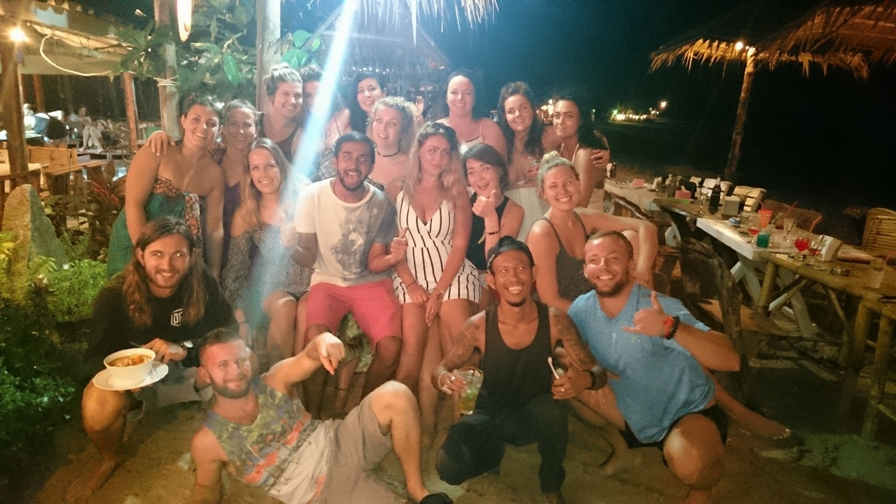 Group of friends dining at a beach restaurant.