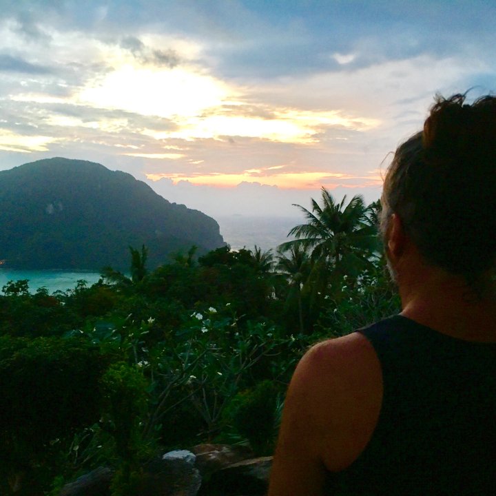 Silhouette of a person watching the sunset over the sea.