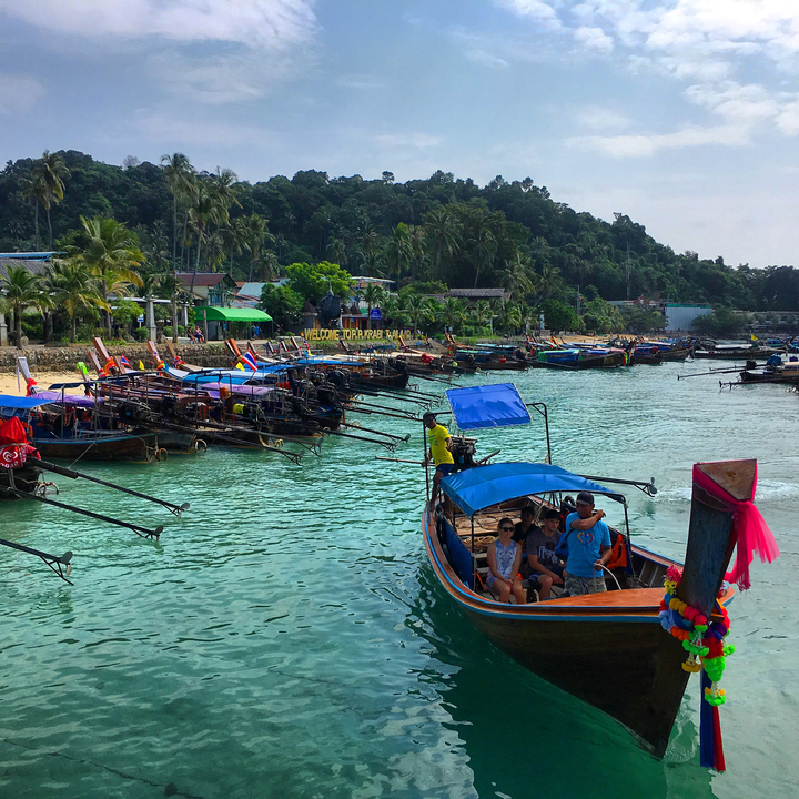 Boats docked at a beach, captured from the water.