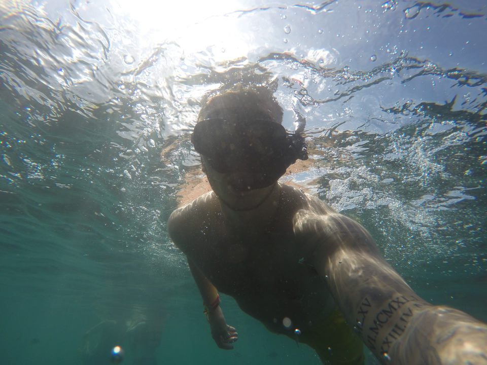 Underwater selfie of a person in snorkeling gear.